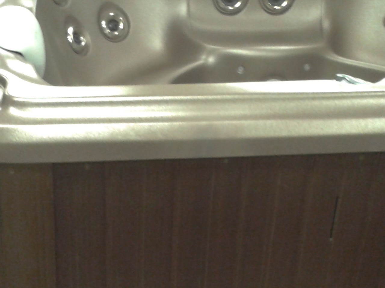 Hot tub with a large crack is color matched and repaired with fiberglass and acrylic methods to a brand new finish